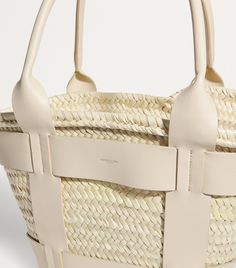 There’s no mistaking the destiny of the Santorini bag by DeMellier – after all, one quick glance at the woven basket silhouette is enough to confirm its beachy fate. Looks aren’t all it has to offer, though; handwoven in Morocco from natural palm leaves, it expertly adheres to the label’s dedication to sustainable, artisanal practices. Demellier Santorini, Woven Basket, Woven Design, Fine Watches, Trainer Boots, Shoes Heels Pumps, Boots Knee, Luggage Accessories, Men's Beauty