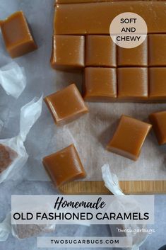 several pieces of chocolate sitting on top of a cutting board next to plastic wrappers