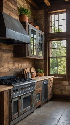 a kitchen with an oven, stove and cabinets in it's center wall that has wood paneling on the walls