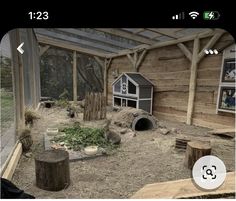 an image of a dog house made out of wood and logs in the middle of a yard