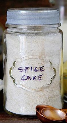 there is a jar that says spice cake next to some spoons on the table