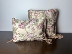 two pillows sitting on top of a wooden table