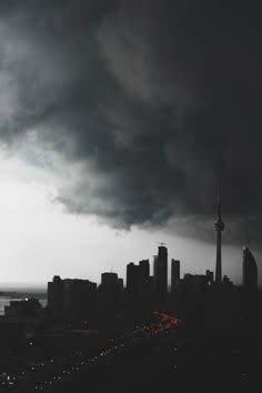 dark clouds hover over a city at night