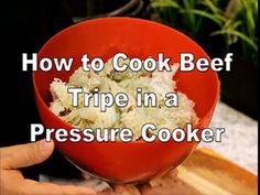 a person holding a red bowl with food in it and the words how to cook beef tripe in a pressure cooker