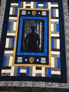 a blue and black quilt with an image of a man in the center on it