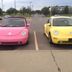 two yellow and pink cars parked in a parking lot