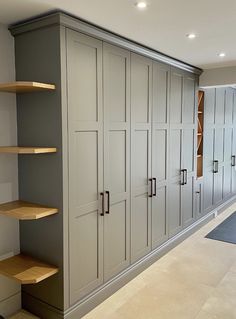 an empty room with shelves and cupboards in it