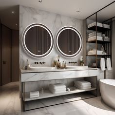 a bathroom with two round mirrors above the sinks and a bathtub in front of it