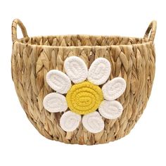 a woven basket with white and yellow flowers in the center, on a white background