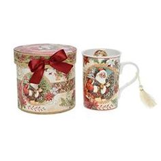 two coffee mugs decorated with santa claus and other christmas related items, one has a tassel on the handle