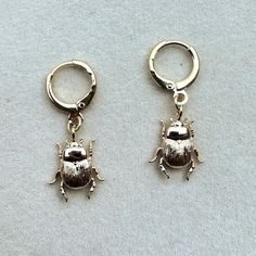 Tiny Beetle Huggie earrings. Handmade, 18k gold plated over stainless steel.