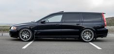 a black station wagon parked in a parking lot