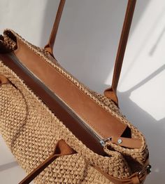 the inside of a straw bag with zippers and handles, on a white background