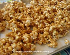 a tray filled with caramel popcorn on top of a table