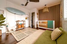 a living room filled with furniture and a surfboard mounted to the wall above it