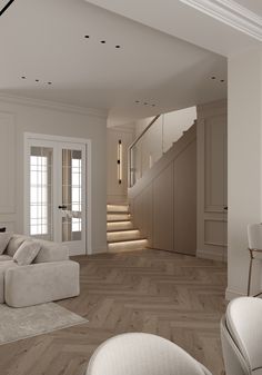 a living room filled with white furniture and wooden flooring next to a stair case