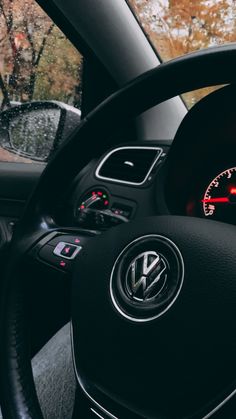 the dashboard of a volkswagen car with its lights on