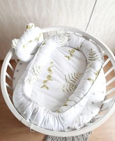 a white baby crib with two pillows on it