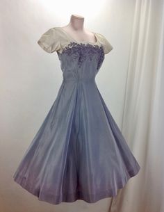 "1950's two-tone party dress in a bluish-gray & cream taffeta with a fitted bodice detailed with soutache embroidery, prong set rhinestones & Pearls . The neckline is an inverted sweetheart shape.. cool yet very sophisticated.. There is a metal zipper that runs up the back of this dress for that perfect hourglass fit. This garment is in EXCELLENT VINTAGE CONDITION. There are a few light watermark spots that are really small here and there.. but nothing distracting. I might have done this 50s Glamour, Soutache Embroidery, 1950s Party Dresses, 27 Inch Waist, Fashion 50s, Oc Outfits, Mood Clothes, Vintage Dresses 50s, Taffeta Dress