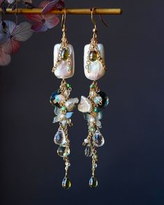 Welcome to visit my Jewelry store:  https://www.etsy.com/shop/Jeansdreamjewelry  Custom order accepted now. Feel free to ask me to see if it is possible. I would love to meet your requirements.  Made to order. Every item will come in a jewelry pouch for safety during travel and gift giving. These dangle earrings are handmade with all natural high quality and well selected gemstones. They are lightweight and comfortable to wear. All materials used are nickel free, friendly to sensitive skin.  🌷MEASUREMENTS Length: 8.8 cm including ear-wire Width: 1.5 cm 🌷GEMSTONE  🔹Dark Green Quartz  🔹White Tone Baroque Pearl 🔹Opal 🔹White Crystal  🔹Czech Lead Glass  🔹Green Crystal  🔹Green Zircon 🌷MATERIALS 🔹14K gold filled ear wire, 14K gold filled wrapping wire, 14K gold filled chain 🌷How to ta Earring Cluster, Garnet Jewelry Set, Dainty Gemstone Jewelry, Red Garnet Jewelry, Czech Jewelry, Kyanite Jewelry, Asymmetrical Earrings, Garnet Jewelry, Natural High