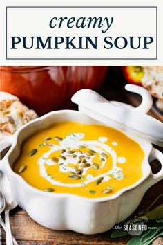 creamy pumpkin soup in a white bowl on a wooden table