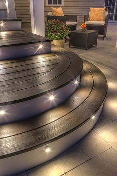 an outdoor patio with steps lit up at night