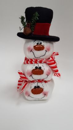 three snowmen are stacked on top of each other