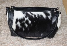 This cowhide shoulder bag is so soft to touch and a real natural, It can make any outfit look complete while protecting your belongings. All our cowhide handbags are free shipping worldwide. You will recieve a cowhide shoulder bag similar to the one shown, we will send you the pattern to choose from and will be custom made to your needs. A perfect blend of cowhide with leather details on these cowhide shoulder purses. Natural cowhide gives this purse an amazing look and look you stunning. Front Black Calf Hair Shoulder Bag For Everyday Use, Black Calf Hair Rectangular Bag, Black Calf Hair Bag With Leather Handles, Black Calf Hair Bags For Everyday Use, Black Calf Hair Bag For Everyday Use, Everyday Black Calf Hair Bag, Shoulder Purses, Cowhide Handbags, Cowhide Bag