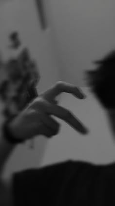 a blurry photo of someone's hands reaching out to touch the camera man