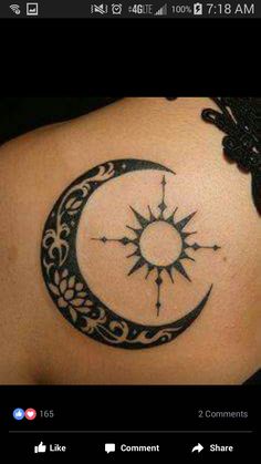 a woman's back shoulder with a crescent and sun tattoo on it