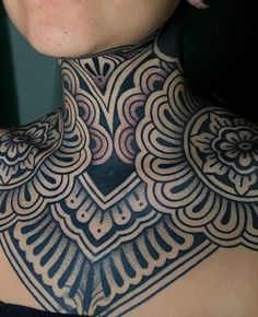 a woman with a black and white tattoo on her neck