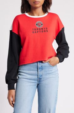 The Women's WEAR by Erin Andrews Heather Red Toronto Raptors Mixed Letter Cropped Pullover Sweatshirt is the perfect way to show your support for the Toronto Raptors. This midweight sweatshirt is made from a soft cotton and polyester blend, making it comfortable to wear all day long. The cropped, unfinished hem and embroidered graphics give it a stylish look that will turn heads. Whether you're cheering on the Raptors at the game or just hanging out at home, this sweatshirt is sure to become a f Trendy Red Tops With Ribbed Cuffs, Trendy Red Top With Ribbed Cuffs, Red Long Sleeve Tops With Ribbed Cuffs, Sporty Red Top With Ribbed Cuffs, Red Crew Neck Top For College, Red Winter Tops For College, Red Tops For Fall Streetwear, Erin Andrews, Cropped Pullover