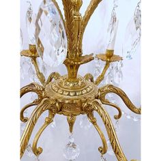 a gold chandelier with crystal drops hanging from it