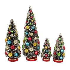 three small christmas trees with ornaments on them