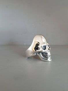 "*RING MAY SLIGHTLY DIFFER FROM PICTURES AS EACH RING IS HANDMADE* .925 Solid Sterling Silver Handmade Skull Ring Each ring is handmade and can be made any size The Weight will vary depending on size (A Size 9 Weighs 21.6 Grams) We have sold many rings around the world and each is custom made through a Lost Wax casting process using a hand cut master pattern Each ring is hand crafted and is stamped on the inside \"STER\" This ring will come with a black ring box and will be wrapped in an anti-ta Black Ring Box, Many Rings, Sterling Silver Skull Rings, Handmade Skulls, Silver Skull Ring, Black Ring, Wax Casting, Lost Wax Casting, Skull Ring