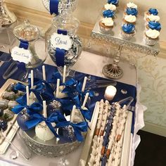 a table topped with lots of cupcakes and candy