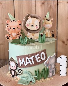 a cake decorated with animals and the word mateo on it's top tier