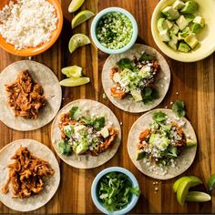 several tacos are laid out on a cutting board