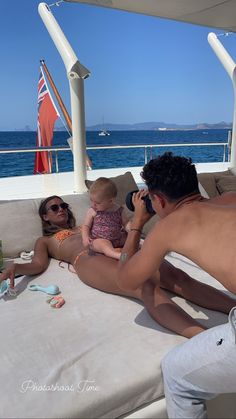 a man and woman sitting on a boat with a baby