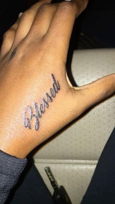 a person with a tattoo on their hand that says,'released'in cursive writing