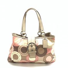 C274 Coach Ashley Snaphead Soho Sateen Handbag This Pink Ashley Satchel Is Preowned And Is In Very Good Condition. The Colors Of This Bag Are A Mixture Of Pink, White And Brown. This Bag Is Composed Of A Sateen Nylon Exterior And Trimmed In Tan Leather Straps And Trim With Silver Colored Hardware. The Inside Of The Bag Is Very Roomy With A Long Side Zipper Insert And A Zipper Insert Divider In The Middle Of The Bag Along With Two Sliip Inserts. The Measurements For This Bag Are As Follows: 14” I Beach Monogram, Y2k Handbag, Tote Coach, Pocket Book, Handbag Purse, Coach Purses, Soho, Tan Leather, Coach Bags