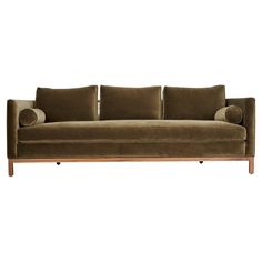 a brown couch sitting on top of a wooden frame