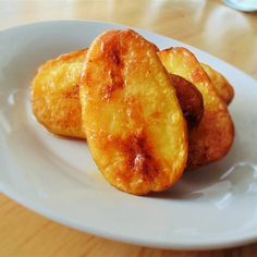 three pieces of fried food on a white plate