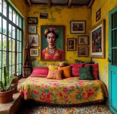 a bedroom with yellow walls and pictures on the wall, colorful bedspread, potted plants