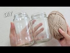 two jars with yarn in them sitting next to each other