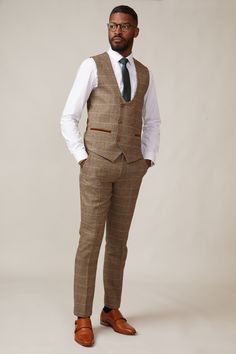 Inspired by old age country wear, the DX7 suit remains an ever so popular style, reminiscent of the 18th century. It is ideal for Autumn/Winter with its earthy colour palette and heavy fabric. A touch of modernism is added with a velvet contrast collar, elbow pads and pocket trims, nudging it back into the 21st century. Perfect for a rustic countryside wedding. Mix-and-match the waistcoat to differentiate from the groomsmen and match your accessories with the bridesmaid dresses. Looking for a pl Brown Single-breasted Tweed Suit, Brown Tweed Jacket For Tailoring, Tailored Brown Tweed Jacket, Classic Brown Double Breasted Suit For Winter, Fitted Single-breasted Tweed Vest, Tailored Brown Tweed Suits, Tailored Single-breasted Tweed Vest, Brown Fitted Tweed Suits, Fitted Brown Tweed Suits