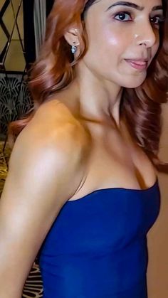 a woman with red hair wearing a blue dress