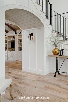 a foyer with white walls and wooden floors