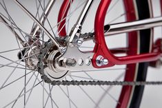 the front wheel of a bicycle with red spokes