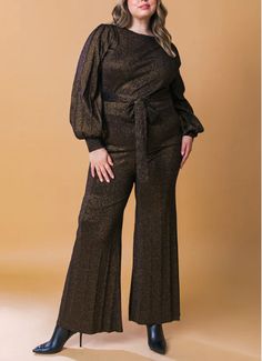 This metallic sweater knit tunic and pant set featuring round neckline, long sleeve, self sash tie and matching wide leg pant is a statement look. Achieve effortless style in this STUNNING STANCE Metallic Sweater Tunic and Pant Set. Crafted from a cozy metallic sweater knit, this set includes a round neckline tunic with long sleeves and a self sash tie, paired with a matching wide leg pant. Look chic and stay warm in this classic ensemble. DescriptionA metallic sweater knit tunic and pant set fe Fitted Sequined Long Sleeve Pant Set, Metallic Long Sleeve Holiday Tops, Elegant Gold Long-sleeve Palazzo Set, Luxury Pant Set With Set-in Sleeves, Luxury Pant Set With Set-in Sleeves For Women, Metallic Sweater, Knit Tunic, Tunic Sweater, Metallic Colors